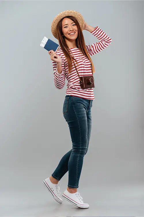 a lady traveller wearing hat holding visa,passport and flight ticket